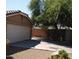 A single-Gathering home featuring a two-car garage and desert landscaping at 7771 N 58Th Ln, Glendale, AZ 85301