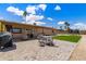 Expansive patio featuring pavers, a dining set, artificial turf, and palm trees in the yard at 858 W Knowles Cir, Mesa, AZ 85210