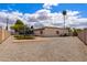 Open backyard with gravel landscaping, a trampoline, picnic table, and mature trees offering shade and character at 858 W Knowles Cir, Mesa, AZ 85210