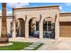 Inviting single-story home showcases a stucco facade, arched entryway, and well-manicured landscaping at 858 W Knowles Cir, Mesa, AZ 85210