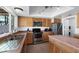 Well-lit kitchen featuring light wood cabinetry, stainless steel appliances, and a functional center island at 858 W Knowles Cir, Mesa, AZ 85210