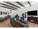 Spacious living room with wood-beamed ceilings, tile flooring, and comfortable seating area at 858 W Knowles Cir, Mesa, AZ 85210