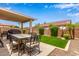 Backyard includes patio seating, artificial turf, palm trees, and block wall at 8788 W Wood Dr, Peoria, AZ 85381