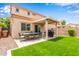 Backyard features outdoor seating, a grill, and artificial turf at 8788 W Wood Dr, Peoria, AZ 85381