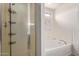 Well-lit bathroom showcasing a glass-enclosed shower and a separate soaking tub for relaxation at 8788 W Wood Dr, Peoria, AZ 85381