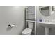 Cozy bathroom features a pedestal sink, toilet, and built-in cabinet with a mirror at 8788 W Wood Dr, Peoria, AZ 85381