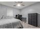 Cozy bedroom with gray walls featuring a desk, gaming chair and dark colored dresser for storage at 8788 W Wood Dr, Peoria, AZ 85381