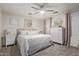 Bright bedroom with plush bedding, white furniture, a ceiling fan, and soft, neutral accents at 8788 W Wood Dr, Peoria, AZ 85381
