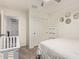 Bright bedroom featuring a crib and geometric mirrors on the wall, creating a cozy and modern space at 8788 W Wood Dr, Peoria, AZ 85381