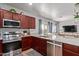 Updated kitchen boasts stainless steel appliances, granite countertops, and ample cabinet space at 8788 W Wood Dr, Peoria, AZ 85381