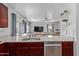 Modern kitchen with stainless steel appliances and an eat-in area perfect for Gathering dining at 8788 W Wood Dr, Peoria, AZ 85381