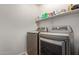 Laundry room features silver washer and dryer with storage shelf above at 8788 W Wood Dr, Peoria, AZ 85381
