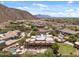 Aerial view showcases the property, highlighting the mountain views, and tranquil surroundings at 9435 E Hobart Cir, Mesa, AZ 85207