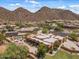 Aerial view displays the expansive property, beautiful desert landscape, and mountain views at 9435 E Hobart Cir, Mesa, AZ 85207