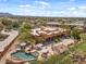 Aerial view of the property featuring a backyard pool and spa, expansive patio, and stunning desert landscape at 9435 E Hobart Cir, Mesa, AZ 85207