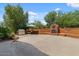 Backyard with built-in seating around a fireplace, outdoor grill area, and ample patio space at 9435 E Hobart Cir, Mesa, AZ 85207