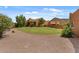 Lush backyard featuring a spacious lawn, desert landscaping, and mountain views, creating a peaceful outdoor retreat at 9435 E Hobart Cir, Mesa, AZ 85207