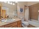 Bathroom featuring tiled shower, toilet, framed mirror, and a wood vanity at 9435 E Hobart Cir, Mesa, AZ 85207