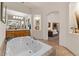 Spacious bathroom with soaking tub, double sinks, and lots of natural light at 9435 E Hobart Cir, Mesa, AZ 85207