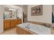 Bathroom with double sinks, separate vanities, soaking tub, and lots of natural light at 9435 E Hobart Cir, Mesa, AZ 85207