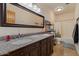 Bathroom features double sink vanity with granite countertop and tiled shower at 9435 E Hobart Cir, Mesa, AZ 85207