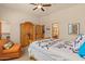 Bedroom features wood accents, closet, ceiling fan, and a bathroom at 9435 E Hobart Cir, Mesa, AZ 85207