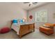 Bedroom with carpet, a ceiling fan, wood bed, chair and a window with plantation shutters at 9435 E Hobart Cir, Mesa, AZ 85207