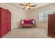Bedroom with carpet, window with plantation shutters, ceiling fan and furniture at 9435 E Hobart Cir, Mesa, AZ 85207