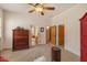 Bedroom featuring carpet, ceiling fan, and wood furniture at 9435 E Hobart Cir, Mesa, AZ 85207