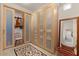 Walk-in closet with custom shelving, frosted glass doors, rug, and chair at 9435 E Hobart Cir, Mesa, AZ 85207