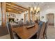 Elegant dining room with exposed beams, wood accents, tiled floors, and comfortable seating at 9435 E Hobart Cir, Mesa, AZ 85207