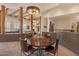 Open-concept dining room with exposed beams, decorative lighting, and ample natural light at 9435 E Hobart Cir, Mesa, AZ 85207