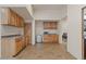 Kitchenette features wood cabinets, sink, mini fridge, and tile flooring at 9435 E Hobart Cir, Mesa, AZ 85207