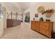 Comfortable living area with wood accents, neutral walls, tiled floors, and a decorative cabinet at 9435 E Hobart Cir, Mesa, AZ 85207