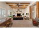 Living room features exposed wood beams, fireplace, and comfortable seating, perfect for relaxation and entertaining at 9435 E Hobart Cir, Mesa, AZ 85207