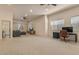 Spacious living room with carpet, multiple ceiling fans, and an adjacent bathroom at 9435 E Hobart Cir, Mesa, AZ 85207