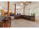 Open living area features a wet bar, columns, abundant windows, and view to the kitchen and dining areas at 9435 E Hobart Cir, Mesa, AZ 85207
