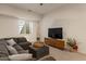 Comfortable living room with gray sectional couch and modern entertainment center at 9435 E Hobart Cir, Mesa, AZ 85207