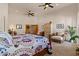 Large main bedroom with a seating area, ceiling fan, and natural light at 9435 E Hobart Cir, Mesa, AZ 85207