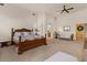 Large main bedroom with a seating area, decorative bed, and ensuite bathroom at 9435 E Hobart Cir, Mesa, AZ 85207