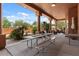 Expansive covered patio with a large picnic table perfect for outdoor dining and entertaining guests at 9435 E Hobart Cir, Mesa, AZ 85207