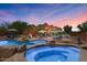 Backyard pool and spa area with lounge chairs and desert landscaping at 9435 E Hobart Cir, Mesa, AZ 85207