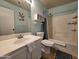 Bathroom featuring shower-tub combination, single sink vanity, toilet, and decorative accents at 9983 W Monterosa Ave, Phoenix, AZ 85037
