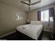 Bedroom with a queen bed, geometric wall decor, ceiling fan, dark wood floors and dresser at 9983 W Monterosa Ave, Phoenix, AZ 85037