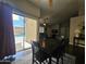 Charming dining area with dark wood table set and sliding glass door at 9983 W Monterosa Ave, Phoenix, AZ 85037
