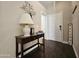 Inviting entryway featuring a decorative table, stylish lamp, and 'Welcome' sign at 9983 W Monterosa Ave, Phoenix, AZ 85037