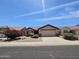 Charming single-story home with desert landscaping, mature shrubbery, and a two-car garage at 9983 W Monterosa Ave, Phoenix, AZ 85037