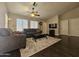 Inviting living room with neutral decor, ceiling fan, and natural light from the windows at 9983 W Monterosa Ave, Phoenix, AZ 85037