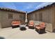 Cozy backyard patio area featuring wicker lounge furniture and an umbrella table at 9983 W Monterosa Ave, Phoenix, AZ 85037