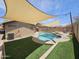 Backyard offers a pool, lounge chairs, artificial turf, and privacy fences at 9983 W Monterosa Ave, Phoenix, AZ 85037
